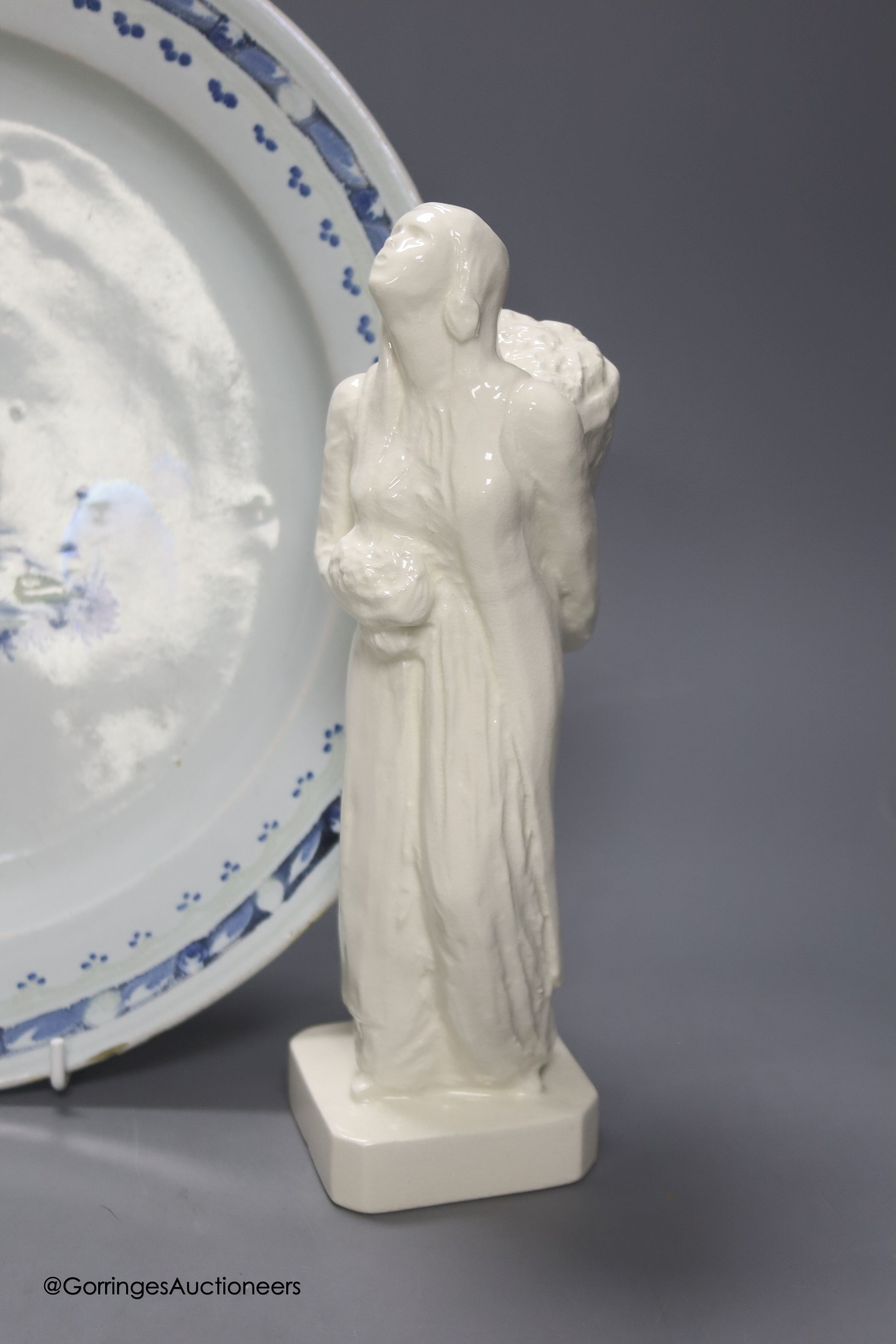 A Continental tin glaze dish, 18th/19th century, possibly Portuguese, a faience Gin barrel, a pottery figure, inscribed in pencil ‘I Barry’ and two Zell Creamware topographical plates